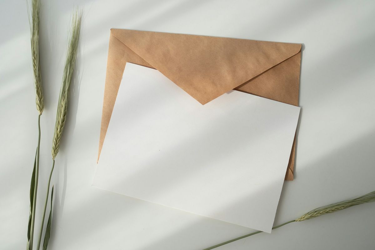 A paper envelope and a blank card in natural light