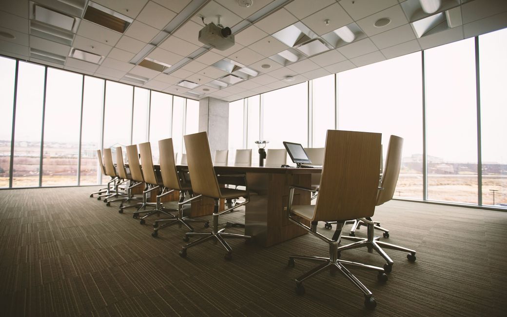 An empty boardroom with a long table